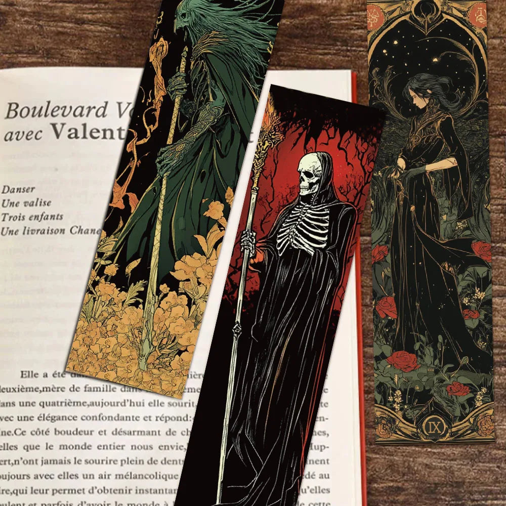 Three artistic prints featuring a skeleton, a woman with a sword, and a green figure on a wooden surface.