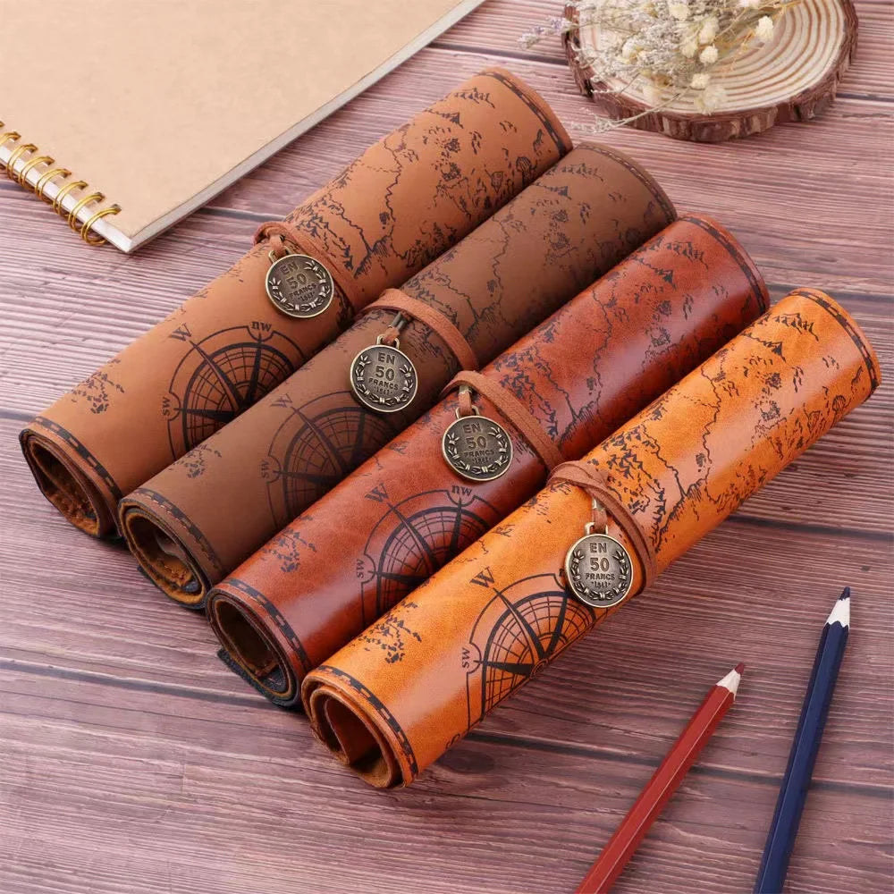 Set of leather roll-up pen cases with map design on a wooden surface
