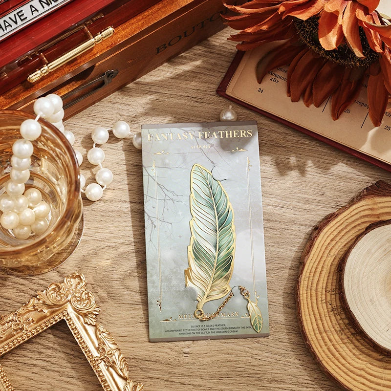 Card with feather design on a wooden surface with decorative items.