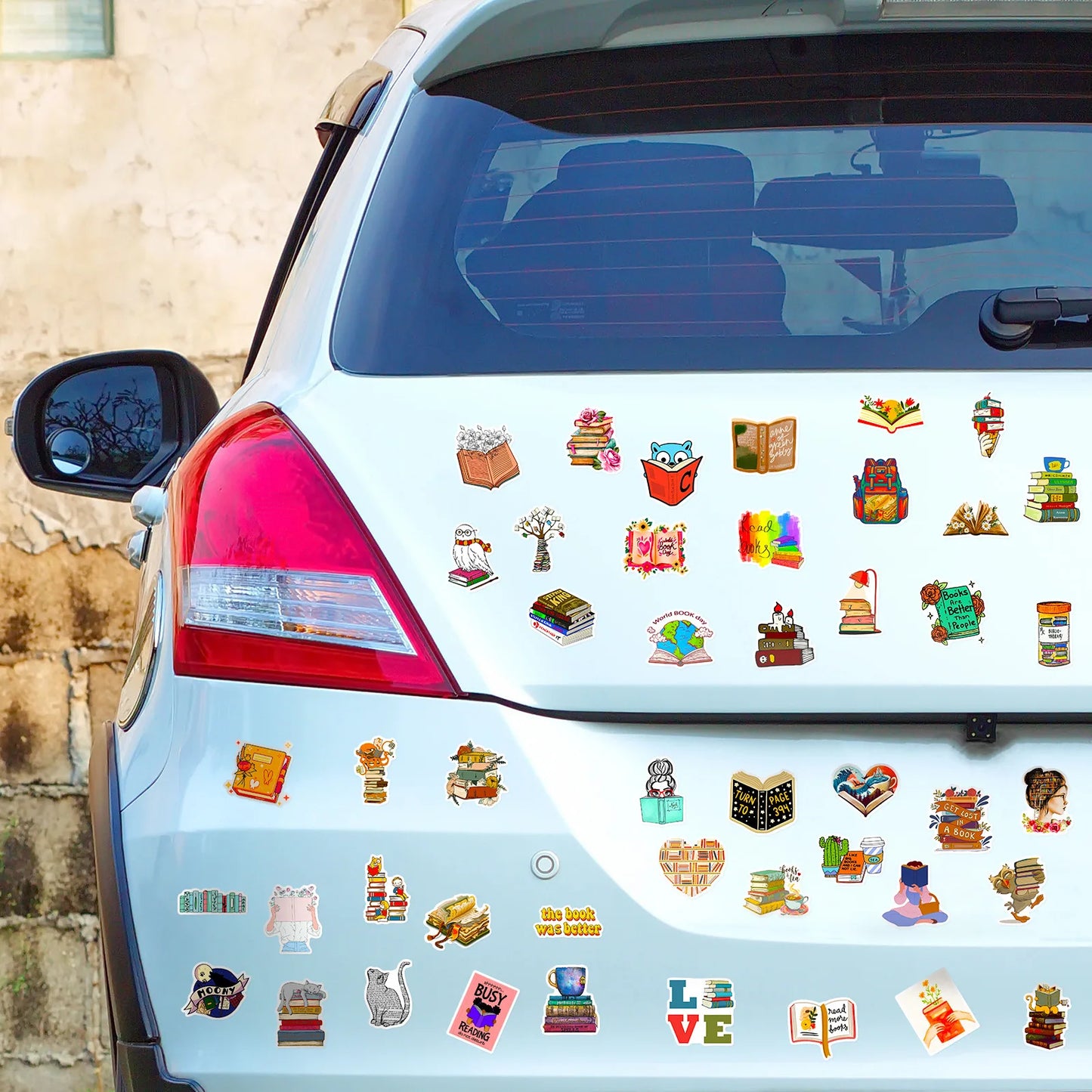 Car with various book-themed stickers on the back window