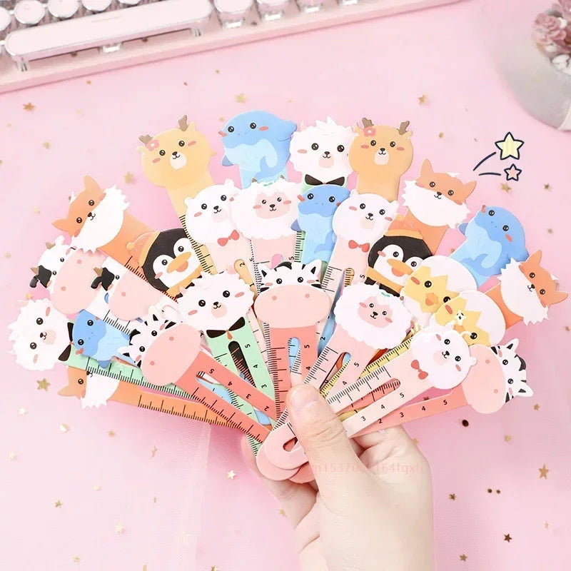 A collection of colorful cartoon animal bookmarks held in a hand, featuring various cute animal designs on each.