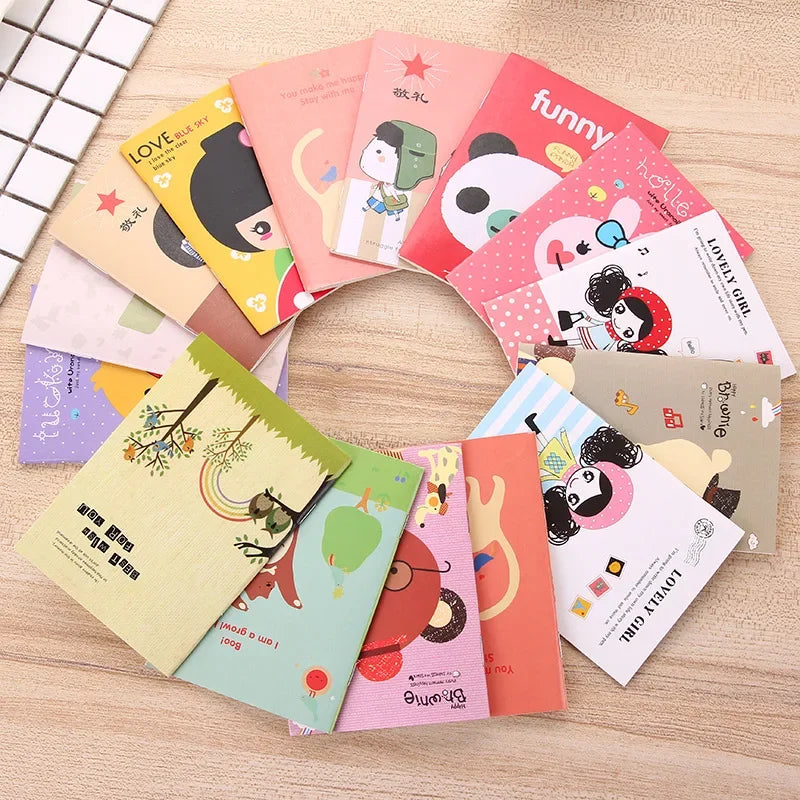 Collection of colorful notebooks with cartoon designs on a wooden surface