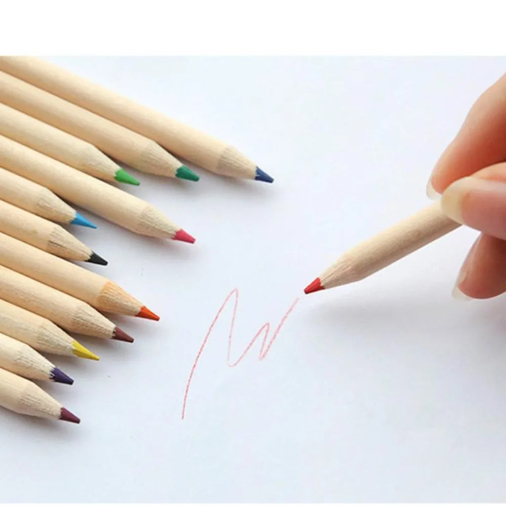 Colorful wooden pencils on a white background with a hand holding one, drawing a heart.