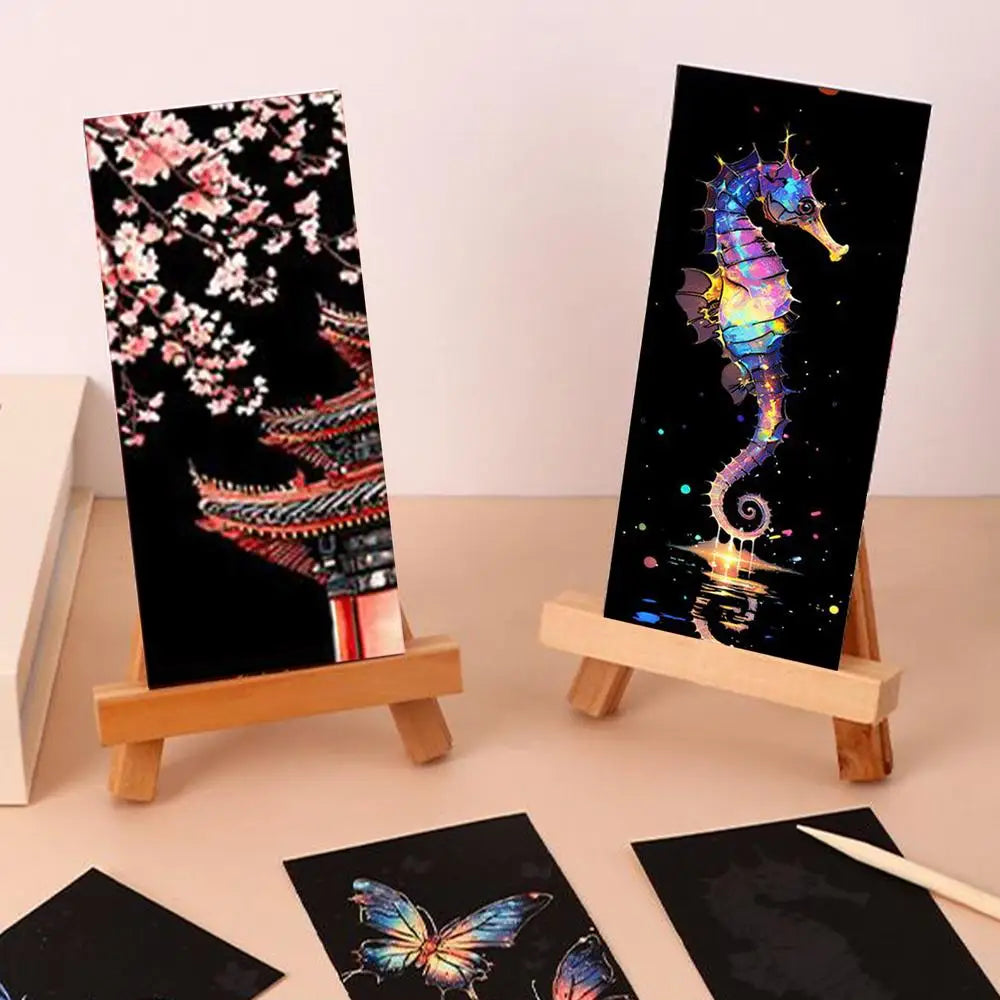 Two diamond painting canvases on small easels with cherry blossoms and a seahorse design.