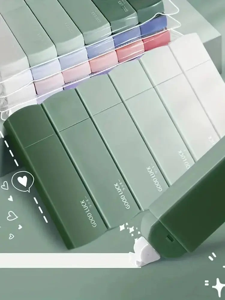 Set of green makeup boxes with visible brand name on a light gray background