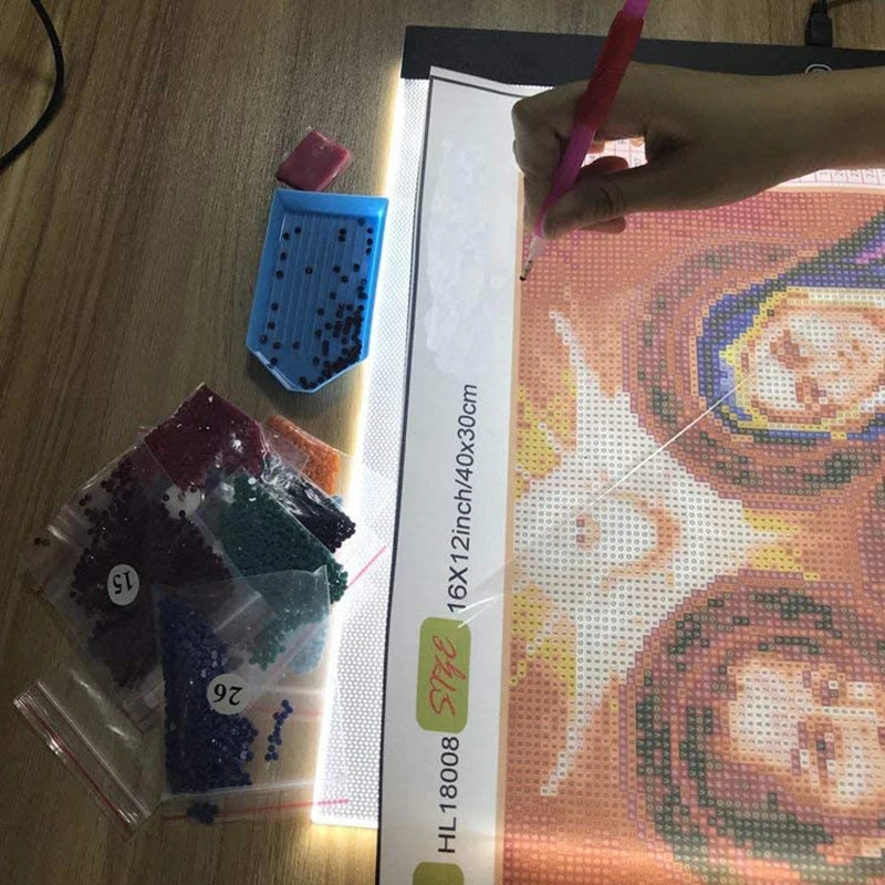 Cross-stitching project with materials on a wooden surface