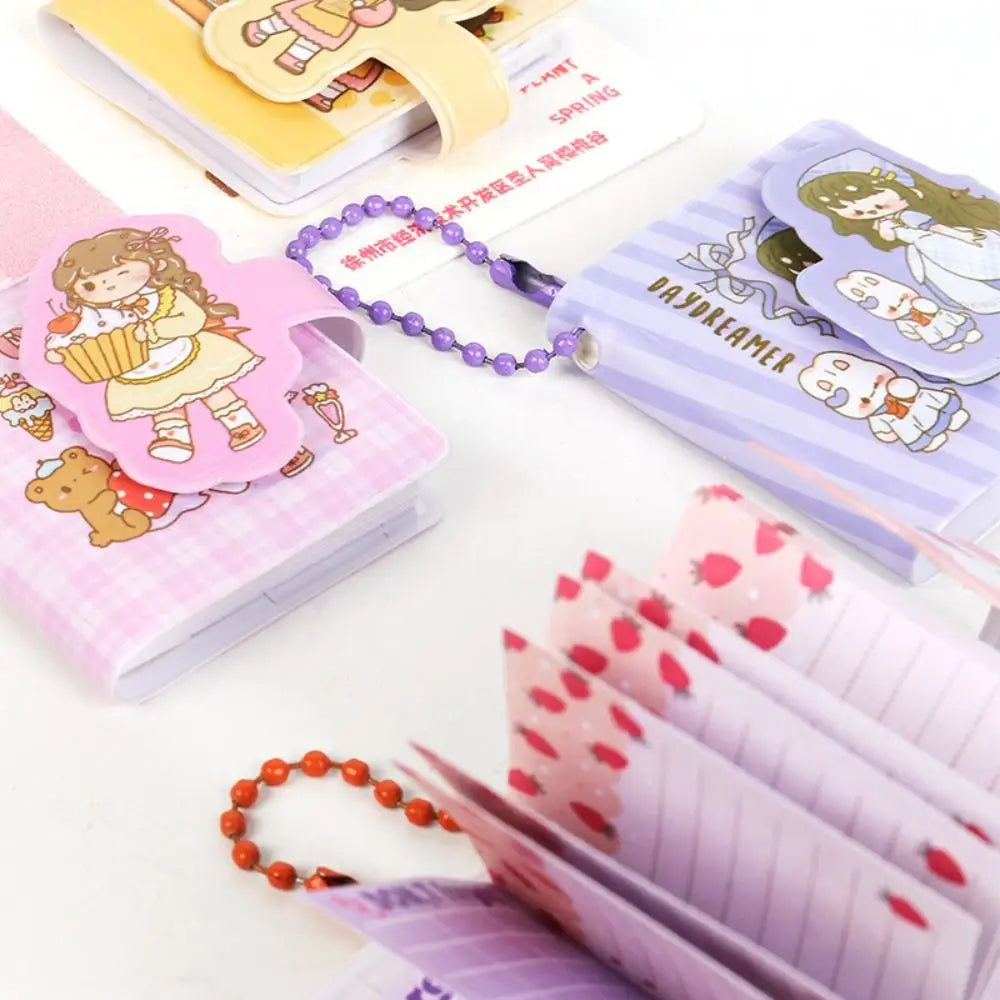 Collection of stationery items including notebooks, bookmarks, and keychains on a white surface.