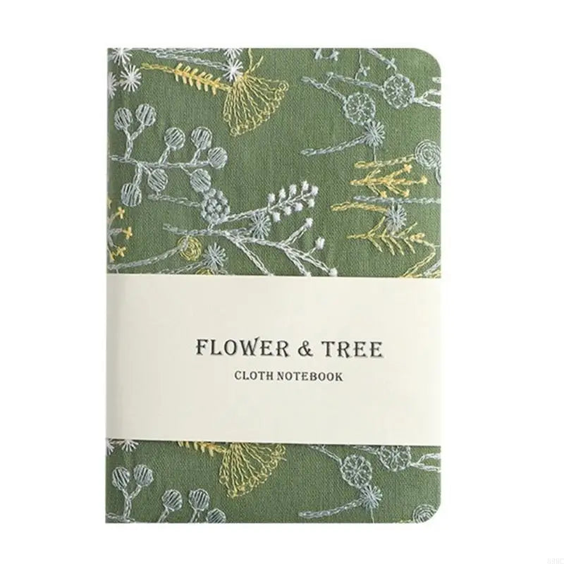 Flower and tree patterned cloth notebook with a green and white design.