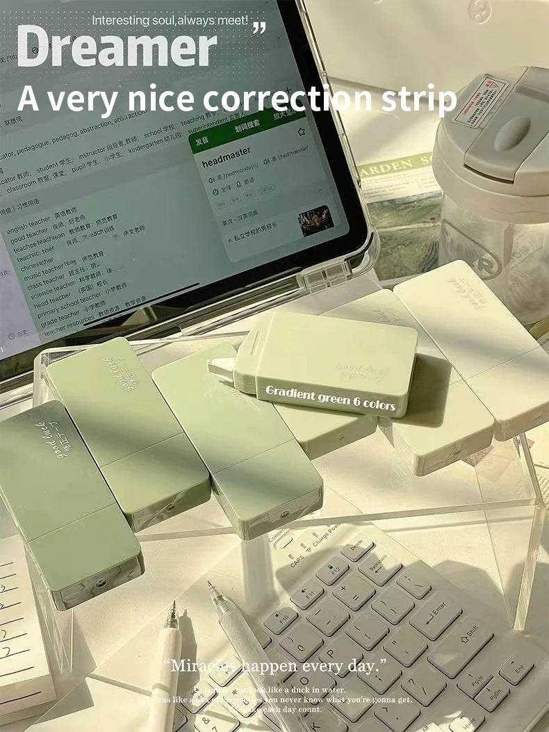 Correction strips on a desk with a laptop in the background
