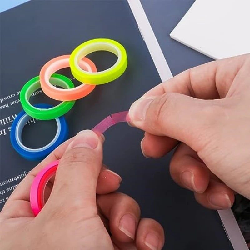 Colorful tape rings on a table with hands interacting with them