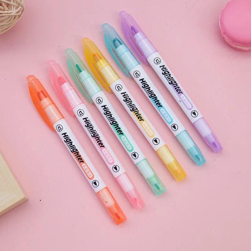 Set of colorful highlighters on a pink background