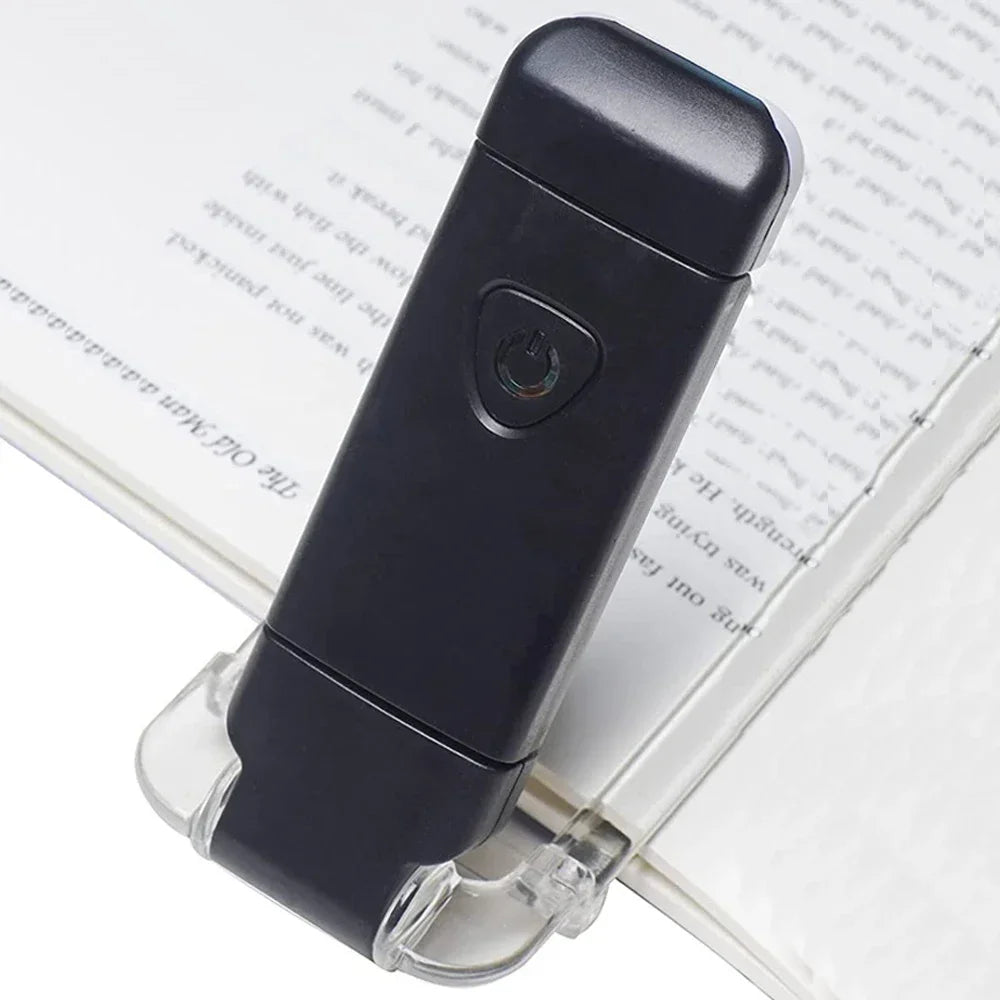 Black handheld device on a book with text