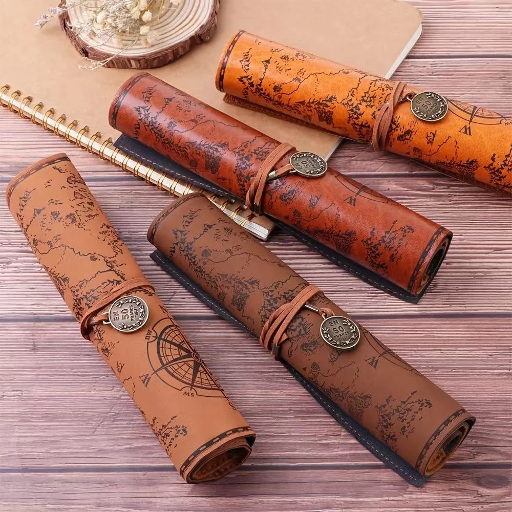 Set of leather-bound notebooks with map design on a wooden surface