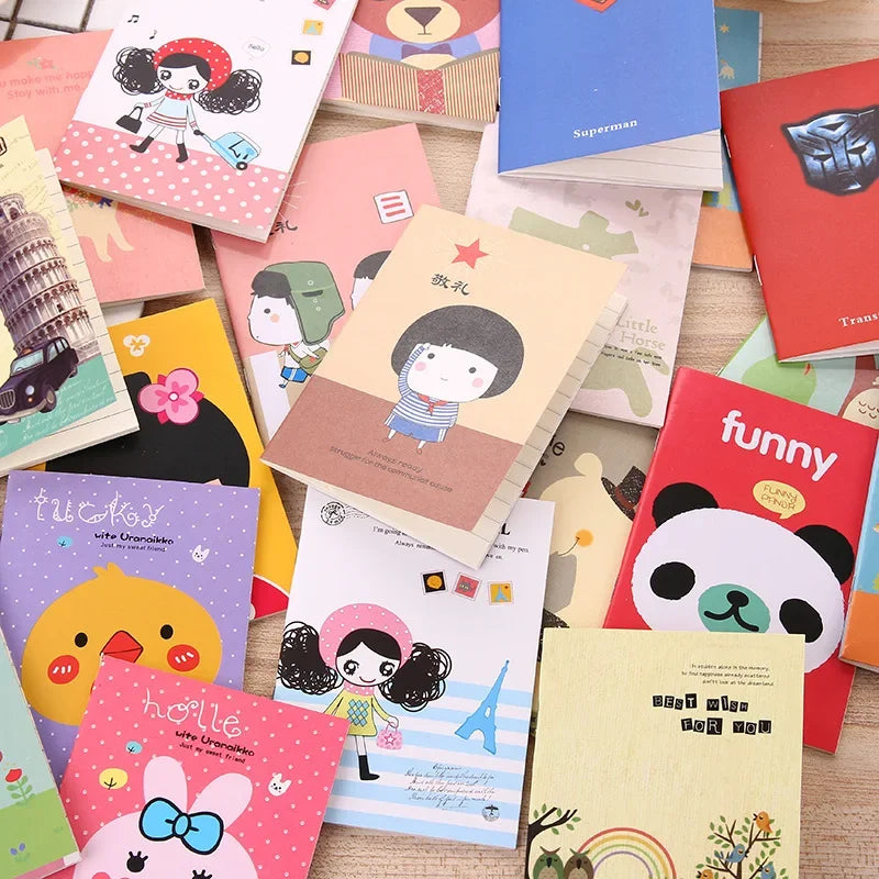 Collection of colorful notebooks with various designs on a wooden surface