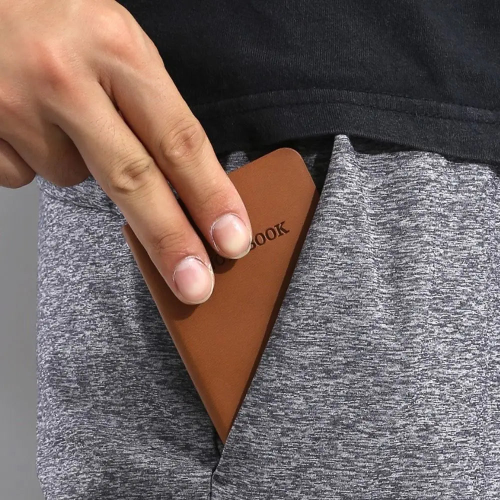 Person inserting a brown leather wallet into their pocket