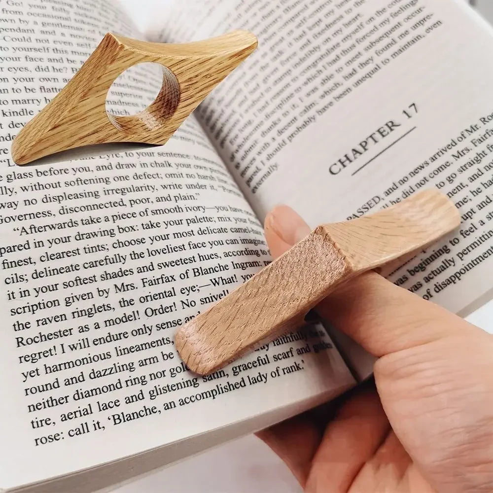 Wooden bookmark being used on an open book
