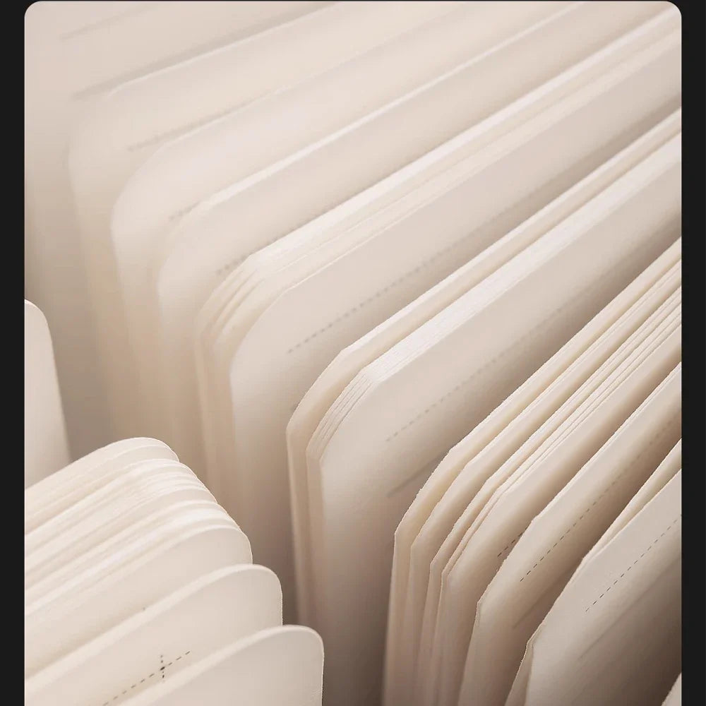 Close-up of beige leather-bound books stacked vertically