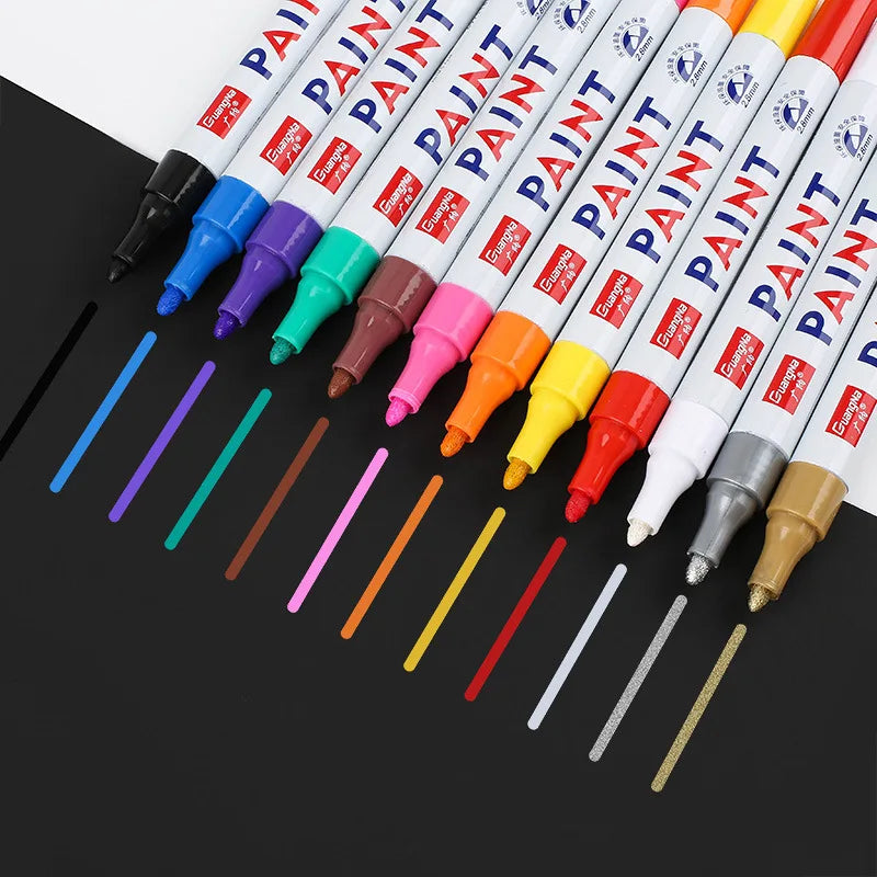 Set of paint markers with color samples on a black background