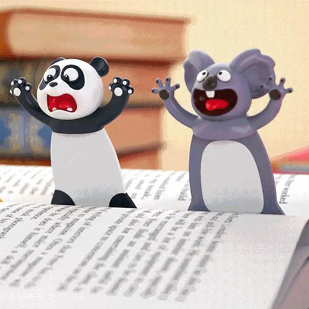 Two cartoon characters, a panda and a koala, on top of an open book.