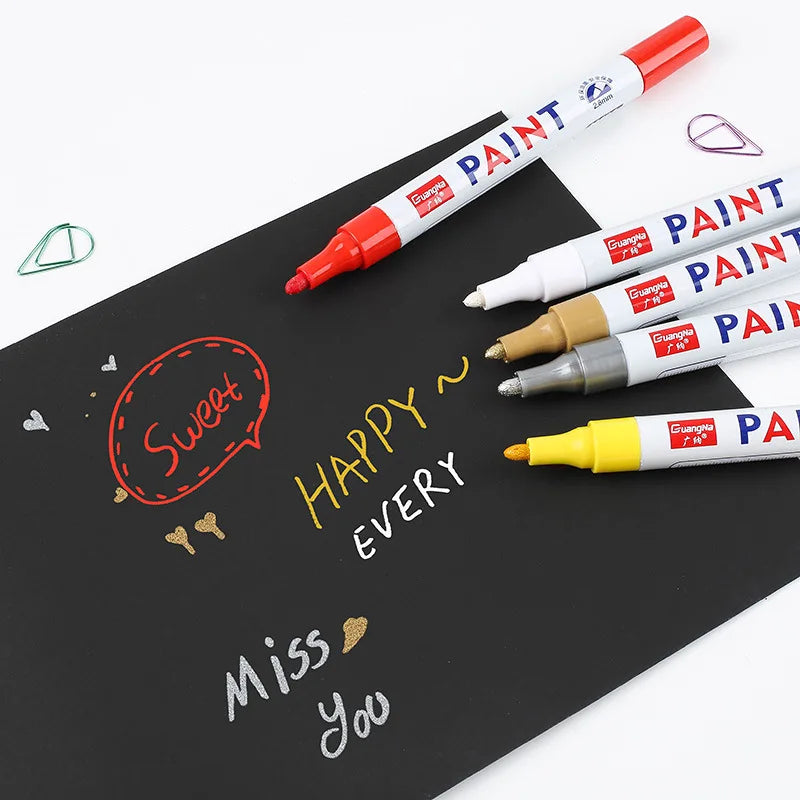 Paint markers on a black surface with written messages