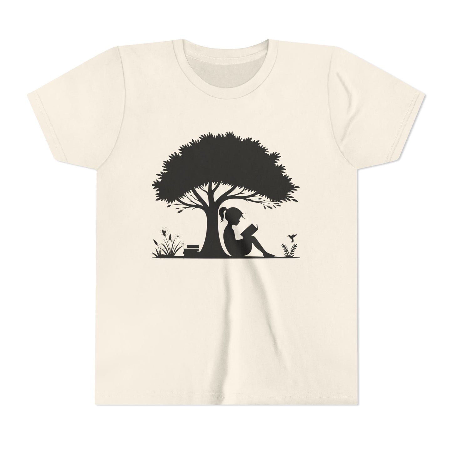 Beige t-shirt with a black silhouette of a girl under a tree reading a book.