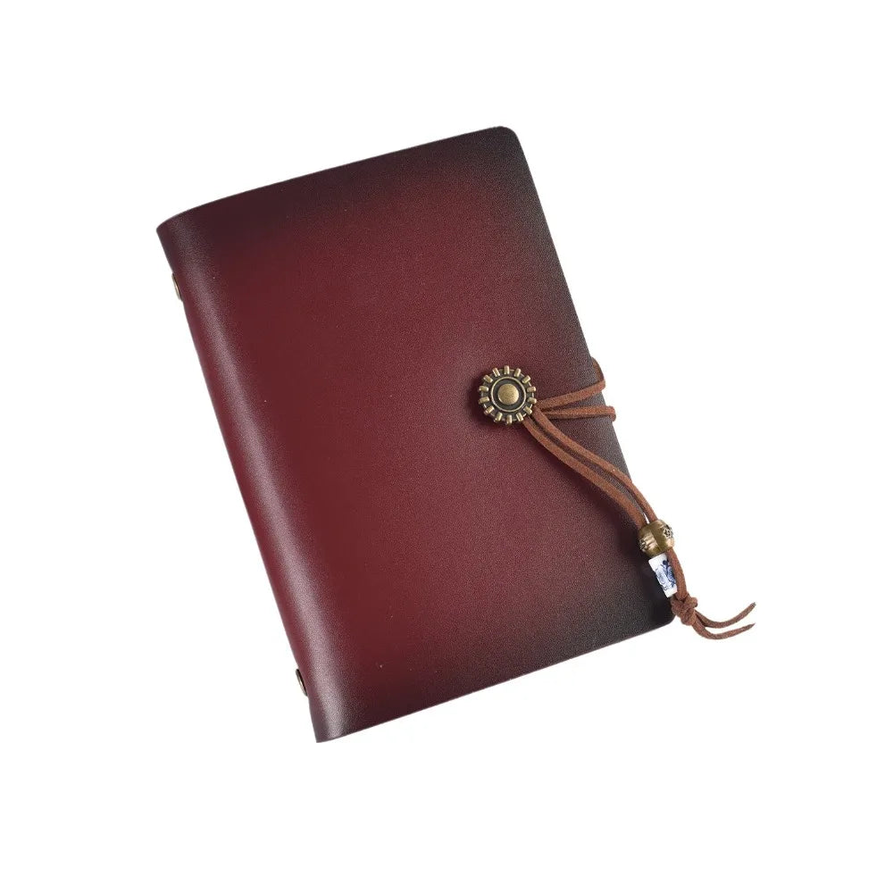 Brown leather notebook with decorative clasp on a white background