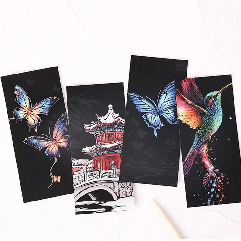 Four black cards with colorful butterfly and hummingbird designs on a white background