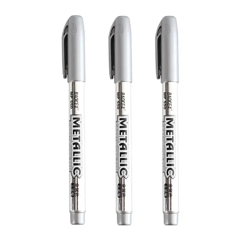 Three metallic markers with clear bodies on a white background
