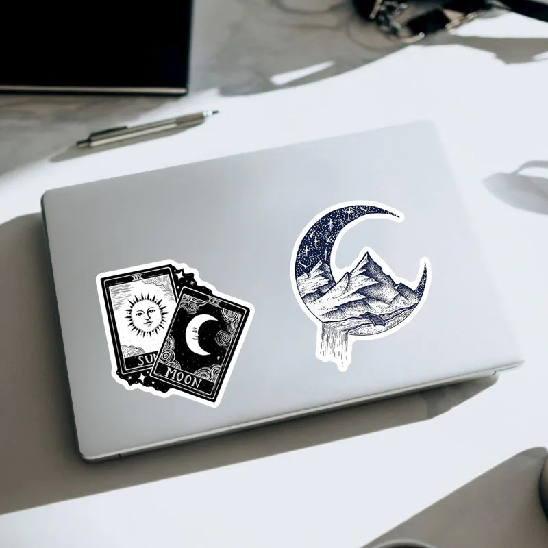 Laptop with two decorative stickers on a desk