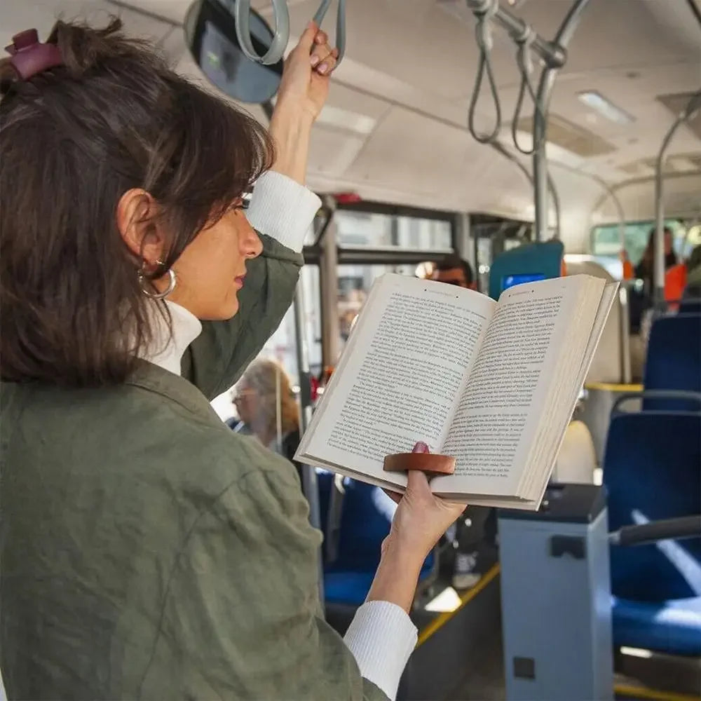 Woman reading a book on a bus