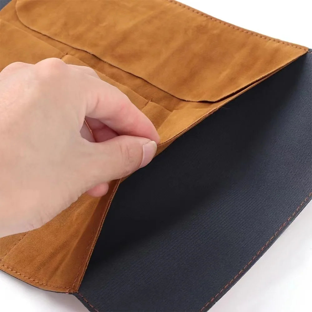 Hand opening a brown leather clutch bag on a white background