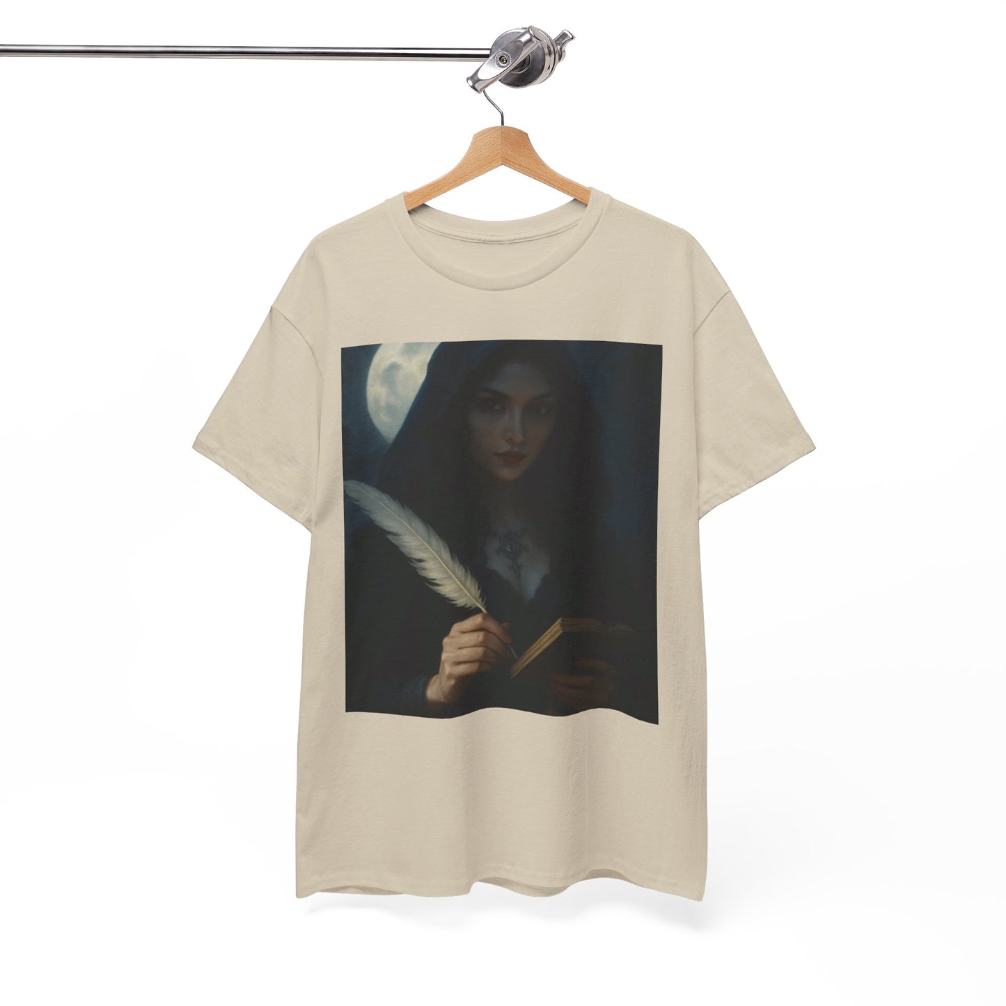 Beige t-shirt with a graphic of a woman holding a feather pen and a book on a hanger against a white background.