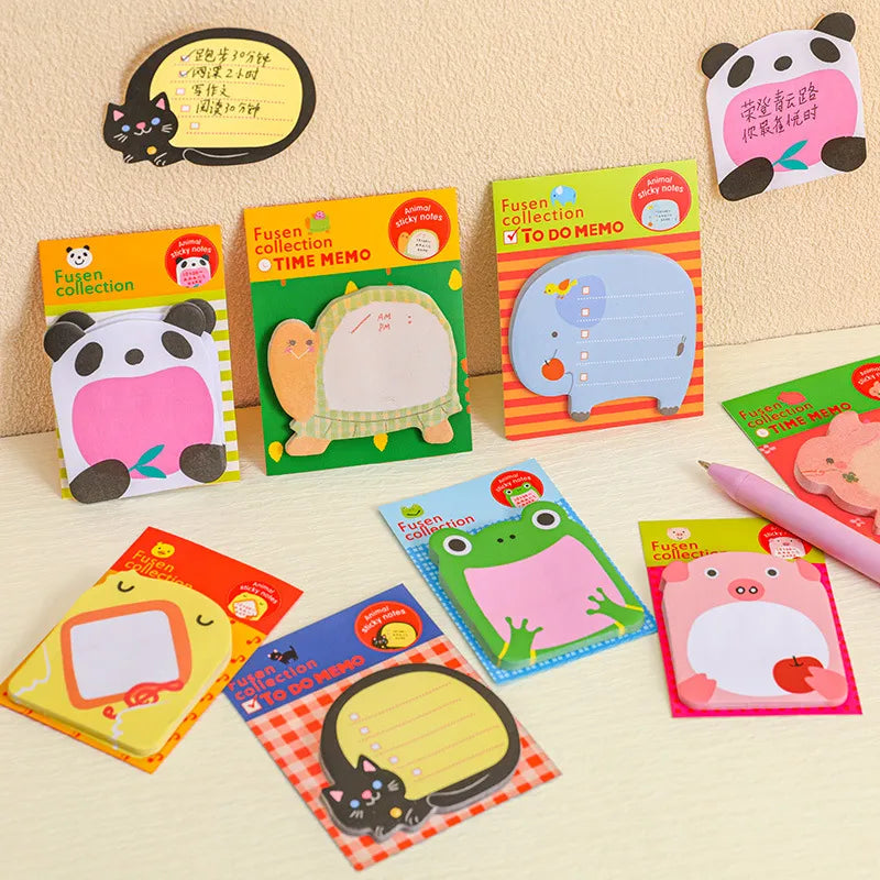 Assorted colorful cartoon animal-themed note pads displayed, with some featuring cute animal designs such as a bear and a frog, and others with simple, playful designs including the word 'MEOW' in a cat's voice. The pads are sticky and designed for writing and note-taking.