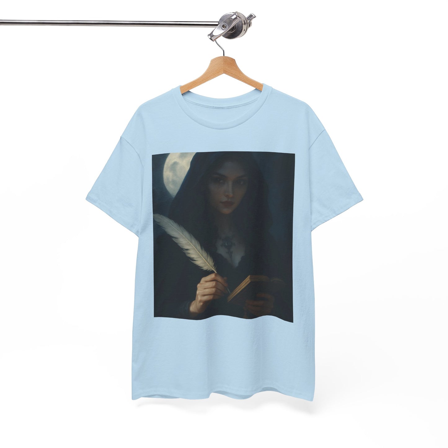 Light blue t-shirt with a graphic design of a woman holding a feather pen and quill, hanging on a wooden hanger against a white background.