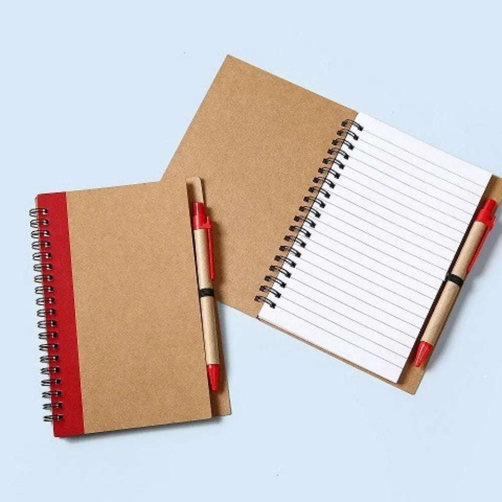 Two brown notebooks with red accents and a pen on a light blue background