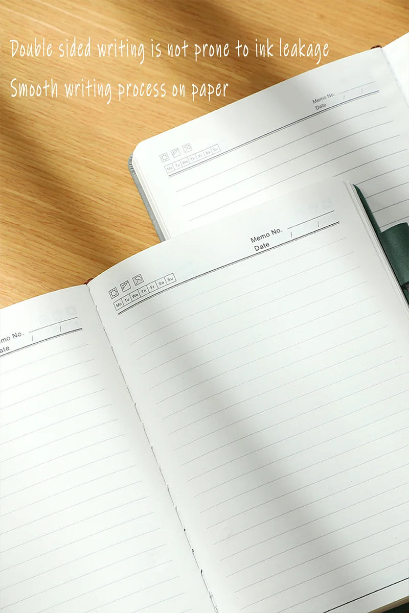 Open notebook with lined pages on a wooden surface