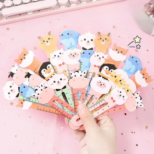 A collection of colorful cartoon animal bookmarks held in a hand, featuring various cute animal designs on each.
