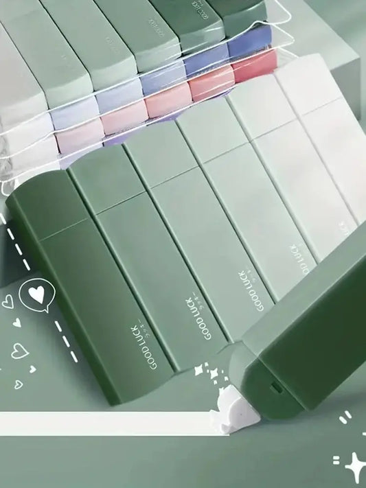 Set of green makeup boxes with visible brand name on a light gray background