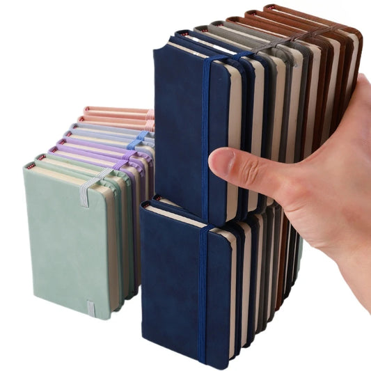 Hand holding a stack of colorful notebooks against a white background