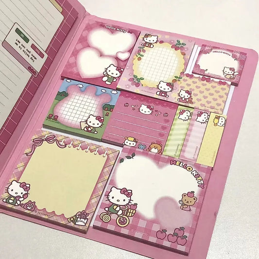 A Hello Kitty themed stationary book with various sticky notes and note papers, featuring characters like Hello Kitty, Mymelody, Kuromi, and Cinnamoroll, arranged in a display spread.