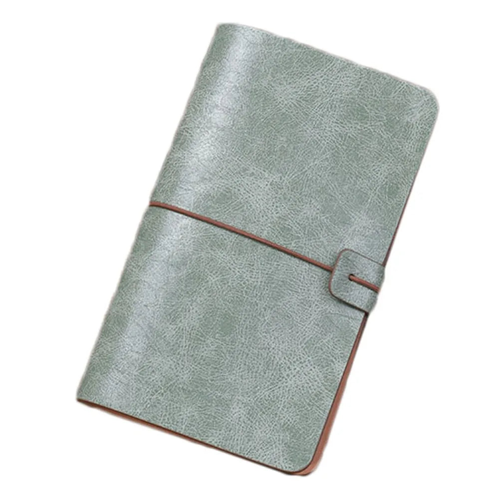 Green leather notebook with a brown strap on a white background