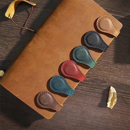 Set of colorful leather clip-on shoe trees on a brown leather surface.
