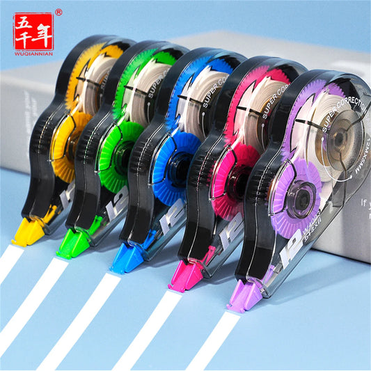 Set of colorful correction tapes with visible brand logo on a blue background