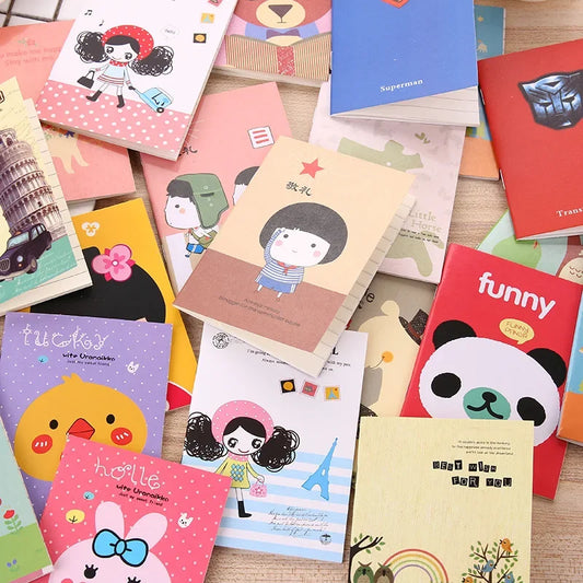 Collection of colorful notebooks with various designs on a wooden surface