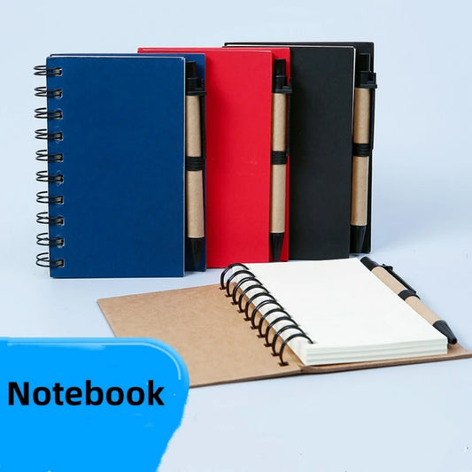 Set of notebooks in blue, red, and black with an open notebook on a light blue background.