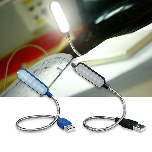 USB LED light with flexible neck on a desk with a computer monitor in the background.
