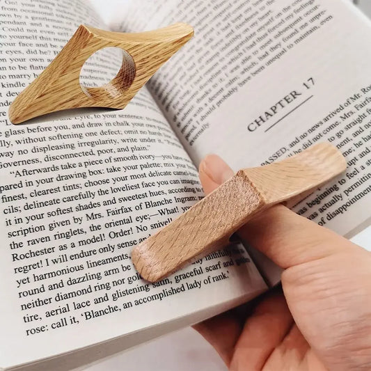 Wooden bookmark being used on an open book