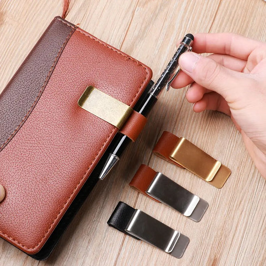 Brown leather wallet with gold and silver money clips on a wooden surface