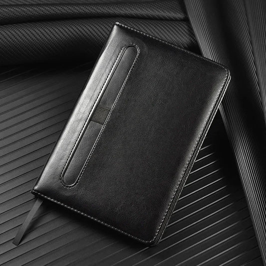Black leather notebook on a textured surface