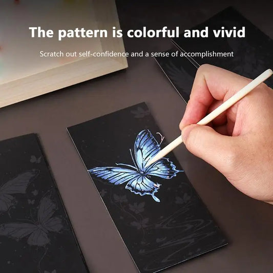 Hand drawing a blue butterfly on a black surface with text about self-confidence and accomplishment.
